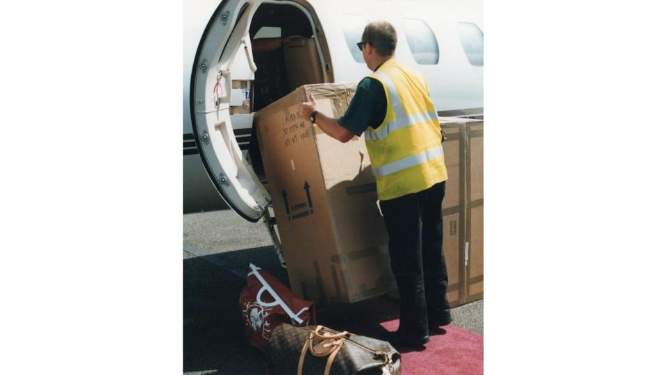 man loading wedding decorations onto the plane