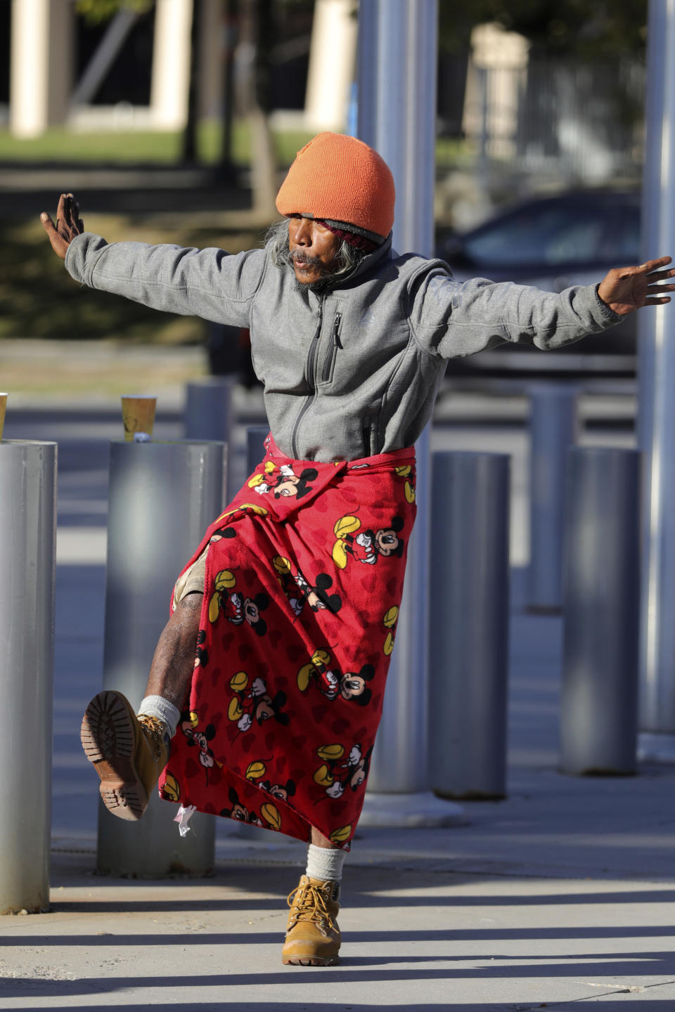 In this Oct. 14, 2019, photo, Biti Arelong performs tai chi at the Salt Lake Police headquarters, in Salt Lake City. The participants are homeless people who take part in a free tai chi program run by a retired couple who started the classes three years earlier. (AP Photo/Rick Bowmer)