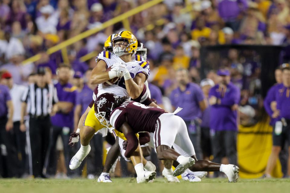 LSU tight end Mason Taylor (86) catches a pass against Mississippi State safety Jackie Matthews (8) during the second half at Tiger Stadium.