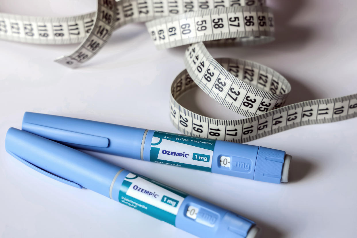 Ozempic insulin injection pen for diabetics next to a measuring tape