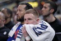 New York Knicks guard Donte DiVincenzo watches from the bench during the second half of Game 4 against the Indiana Pacers in an NBA basketball second-round playoff series, Sunday, May 12, 2024, in Indianapolis. (AP Photo/Michael Conroy)