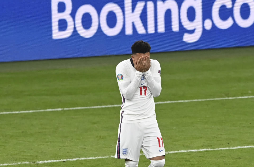 England's Jadon Sancho reacts after missing a chance to score during the penalty shoot out of the Euro 2020 final soccer match between Italy and England at Wembley stadium in London, Sunday, July 11, 2021. (Facundo Arrizabalaga/Pool via AP)