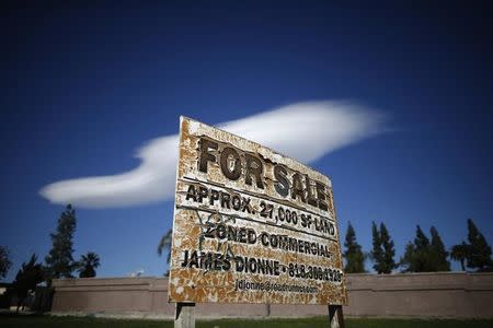 An aging for-sale sign is seen on a plot of vacant land in San Bernardino, California January 23, 2015. REUTERS/Lucy Nicholson