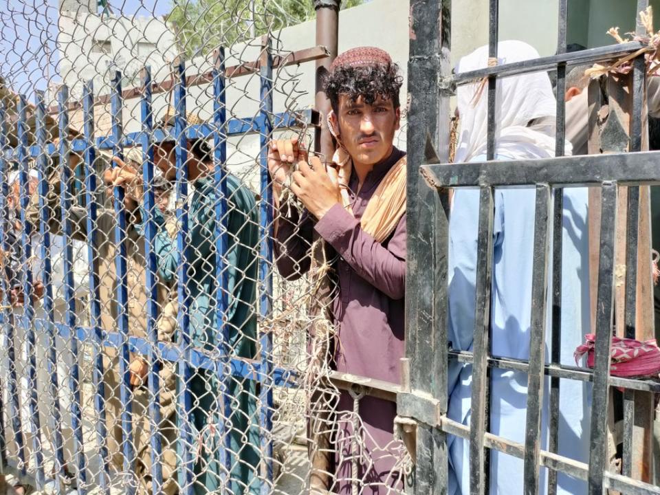 Afghan people wait at the Torkham border crossing to enter Pakistan (Anadolu via Getty)