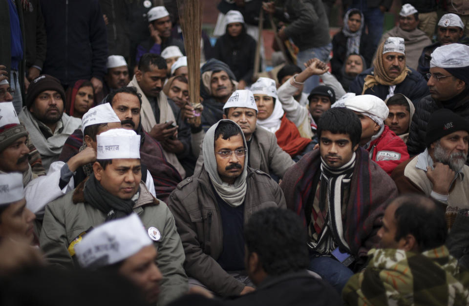 New Delhi Chief Minister Arvind Kejriwal, center, takes part in a protest rally against the police for the second consecutive day, in New Delhi, India, Tuesday, Jan. 21, 2014. The fiery leader of India's capital has accused the police force of targeting the poor for petty offenses and refusing to combat serious crime. (AP Photo/Tsering Topgyal)