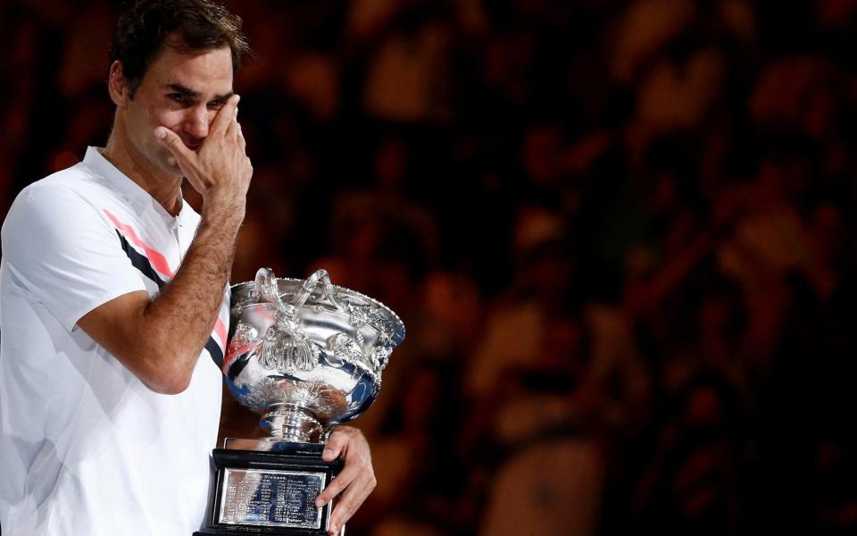 Australian Open - Men's singles final - Rod Laver Arena, Melbourne, Australia, January 28, 2018. Winner Roger Federer of Switzerland cries while holding the trophy - REUTERS