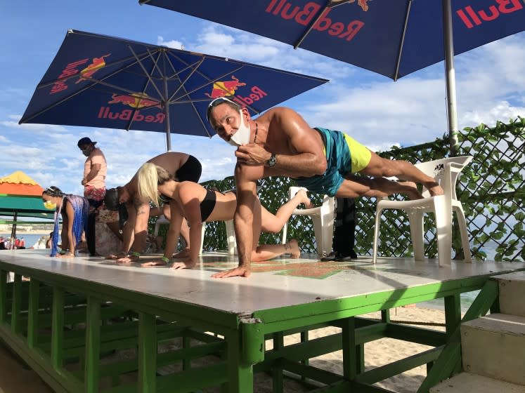 A push-up competition Dec 8 at Mango Deck, a beach bar in Cabo San Lucas, competitors were required to begin with masks, but many quickly fell off.