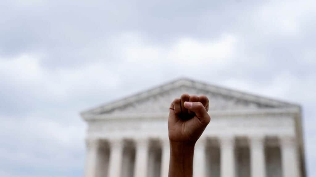 An abortion rights activist stands outside the US Supreme Court in Washington, DC, on June 24, 2022. (Photo by STEFANI REYNOLDS/AFP via Getty Images)