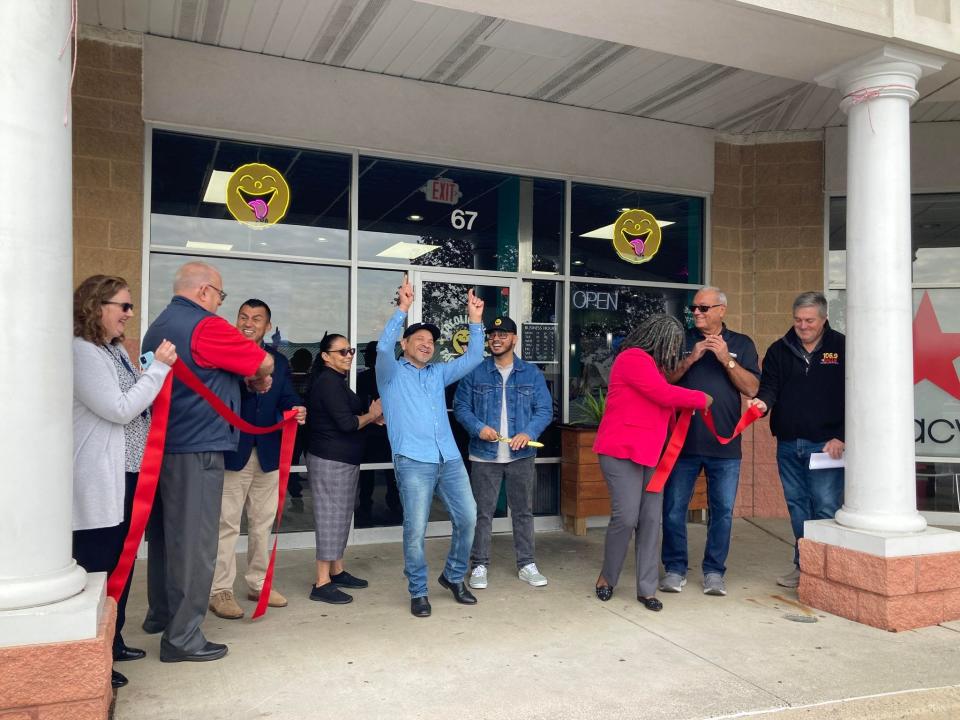 Local officials celebrate the opening of Tacolicious with owners Jay and Carlos Interiano.