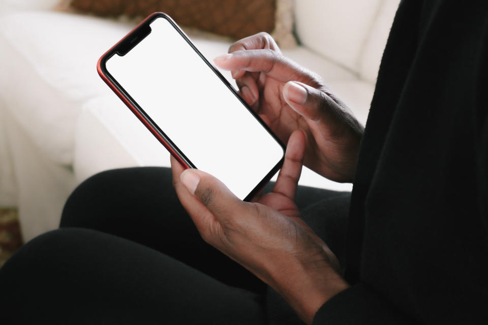 A person's hands touching their smartphone