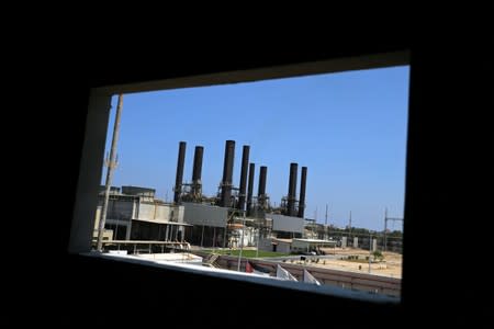 Gaza power plant is seen through a building window, in the central Gaza Strip