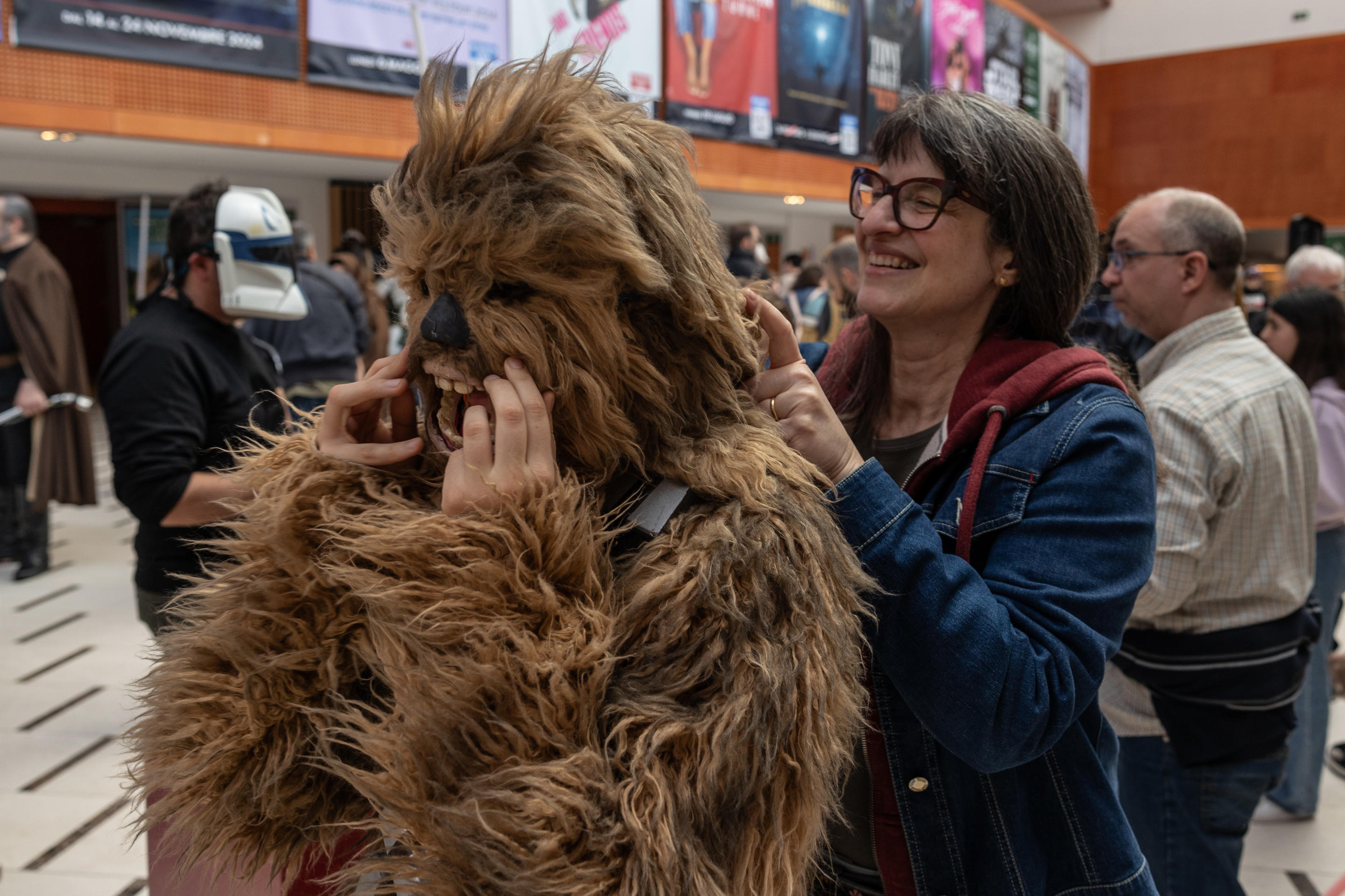 A woman helps her daughter into a Chewbacca costume in Milan.