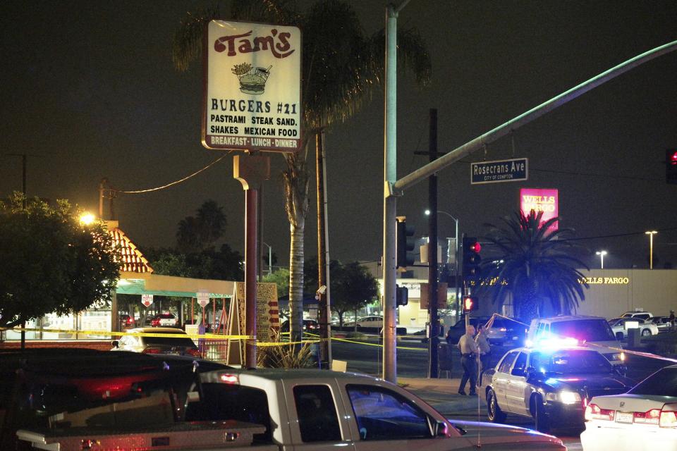 Los Angeles County Sheriff's deputies stand near the scene where a pedestrian was killed in a hit-and-run crash reportedly involving rap mogul Marion "Suge" Knight, in Compton, California January 29, 2015. Knight, 49-year-old co-founder of Death Row Records, was inside the car that struck two people but it was not clear if he was driving, the Los Angeles Times reported. The condition of the second victim was also not immediately known. (REUTERS/Jonathan Alcorn)