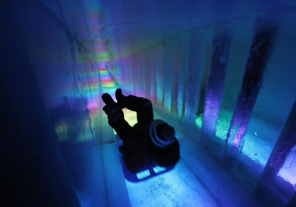 A man zooms down a 97-foot ice slide at Ice Castles in North Woodstock, N.H. (Photo: Robert F. Bukaty/AP)