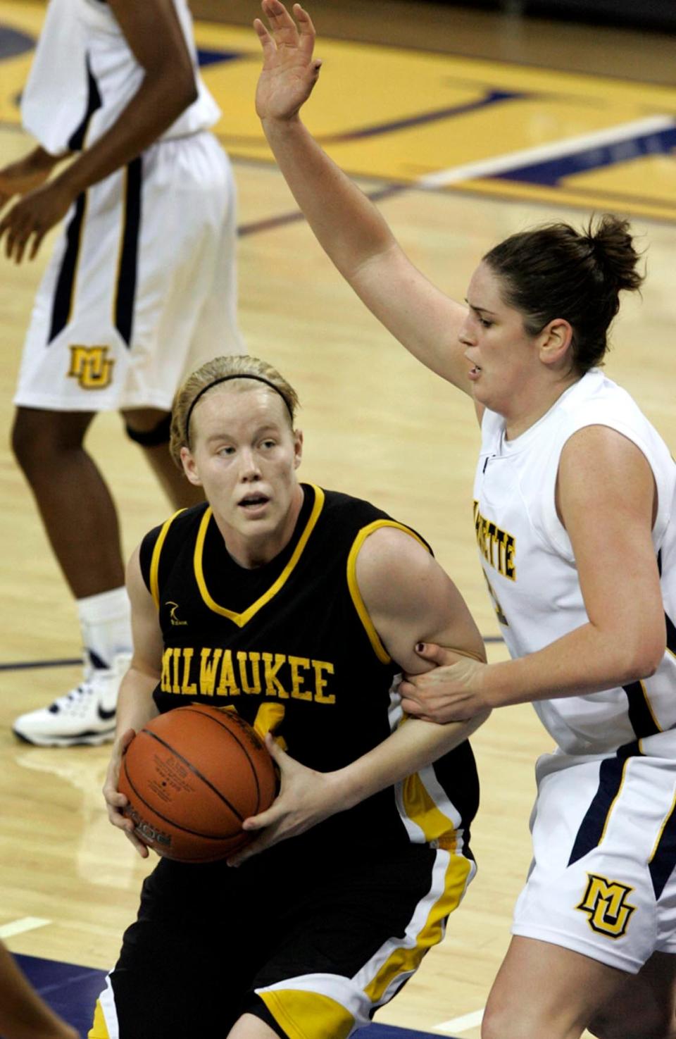 UW-Milwaukee's Traci Edwards (left) moves past Marquette's Jessica Pachko on Dec. 31, 2008.