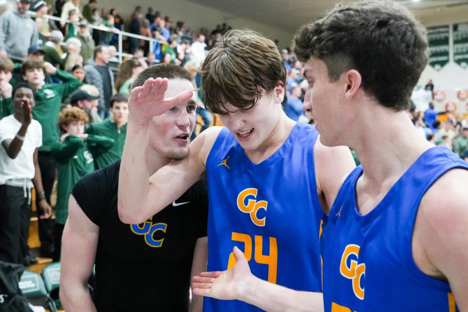 Greenfield-Central Cougars Braylon Mullins (24) celebrates with teammates after making the game-winning basket Friday, Jan. 26, 2024, during the game at Pendleton Heights High School in Pendleton. The Greenfield-Central Cougars defeated the Pendleton Heights Arabians 74-72 in double overtime.