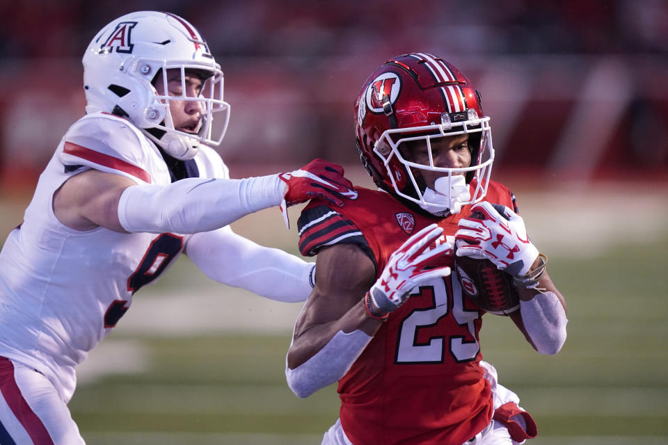Utah wide receiver Jaylen Dixon (25) breaks free from Arizona safety Gunner Maldonado (9) on his way to a touchdown during the first half of an NCAA college football game Saturday, Nov. 5, 2022, in Salt Lake City. (AP Photo/Rick Bowmer)