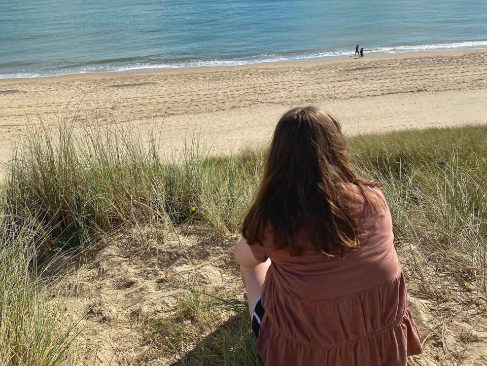 alexis sitting on a beach in ireland