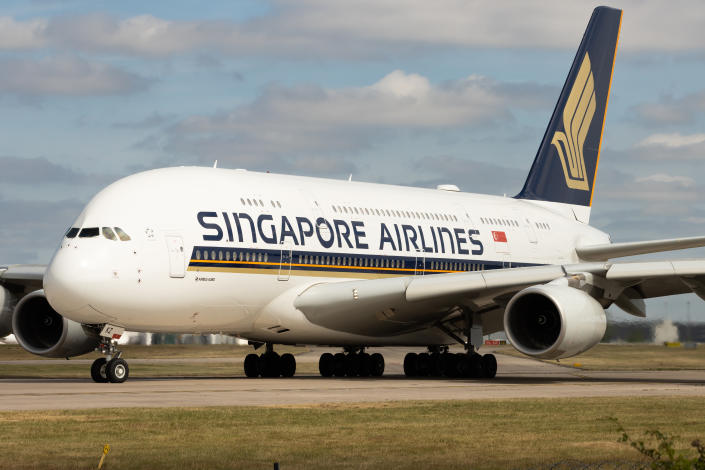 A Singapore Airlines A380-800 on an airport tarmac.