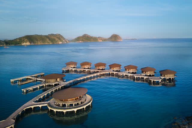 <p>Courtesy of TA’AKTANA, a Luxury Collection Resort & Spa, Labuan Bajo</p> An aerial view of the resort's overwater sea villas.