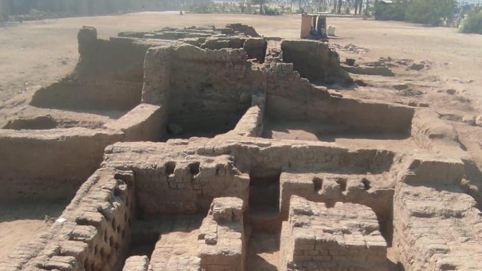 A photo showing the remains the sand-colored remains of what once was a residential building. We see walls and rooms.