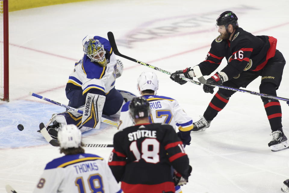 Ottawa Senators Travis Hamonic (16) tries to score against St. Louis Blues goaltender Thomas Greiss, top left, during first-period NHL hockey game action in Ottawa, Ontario, Sunday, Feb. 19, 2023. (Patrick Doyle/The Canadian Press via AP)