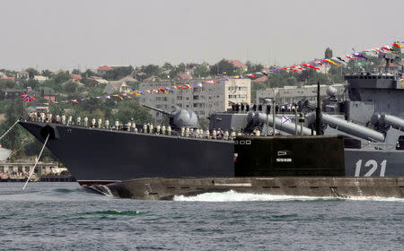 The Rostov-On-Don submarine sails past the guided missile cruiser Moskva during the Navy Day celebrations in Sevastopol, Crimea, July 31, 2016. REUTERS/Pavel Rebrov