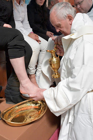 Pope Francis washes the feet of some inmates at the Paliano prison, south of Rome, Italy April 13, 2017. Osservatore Romano/Handout via REUTERS