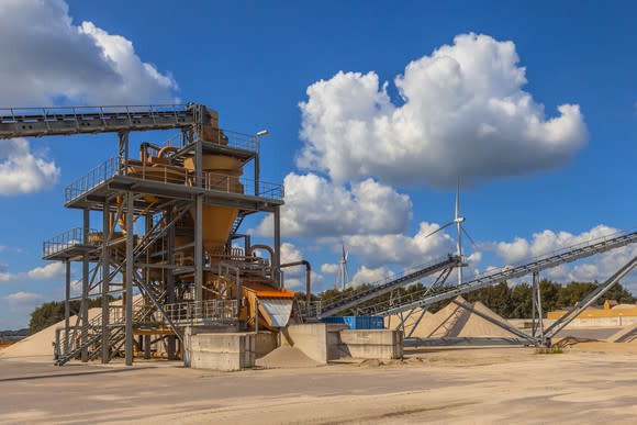 A conveyor belt and hopper at a sand mine.