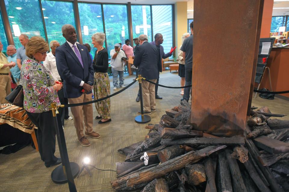 Anderson Mayor Terence Roberts, right, and Kaye Brewer, left, Chief Human Resources Officer of AnMed Health, look at the sculpture by Herman Keith, Jr. during the event "The Strange Fruit of Lynching", by the Pendleton Foundation for Black History and Culture at the Pendleton branch of the Anderson County Library Thursday, June 15, 2023. The sculpture was commissioned by Anderson Area Remembrance and Reconciliation Initiative, a group from Anderson County, with jars with dirt representing soil from sites where men were lynched in Anderson County. Organizers said the ceremony is an ongoing effort to foster dialog, promote education and encourage conversations with a goal of inspiring harmony before the sculpture is moved to AnMed Health North campus, with an unveiling June 19 at 5 p.m. 