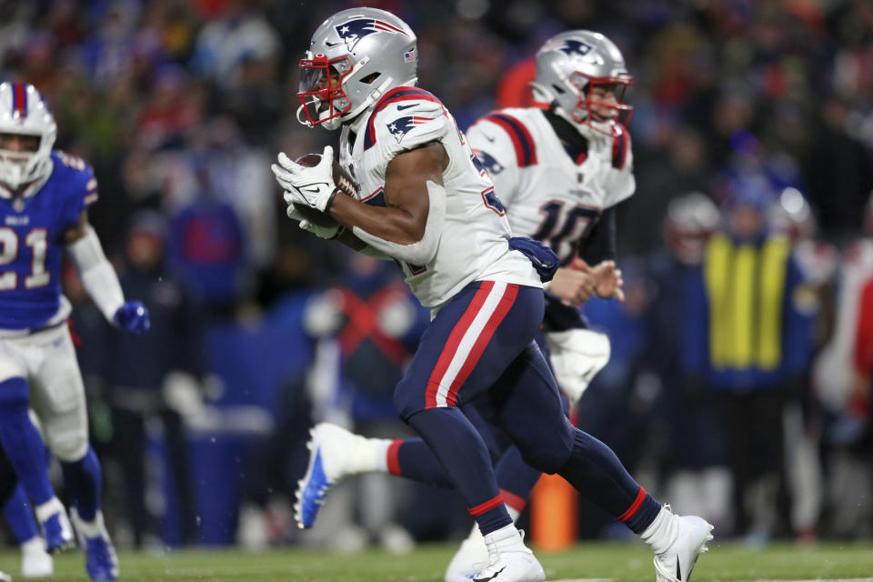 New England Patriots running back Damien Harris, center, takes a hand off from New England Patriots quarterback Mac Jones (10) for a touchdown during the first half of an NFL football game against the Buffalo Bills in Orchard Park, N.Y., Monday, Dec. 6, 2021. (AP Photo/Joshua Bessex)