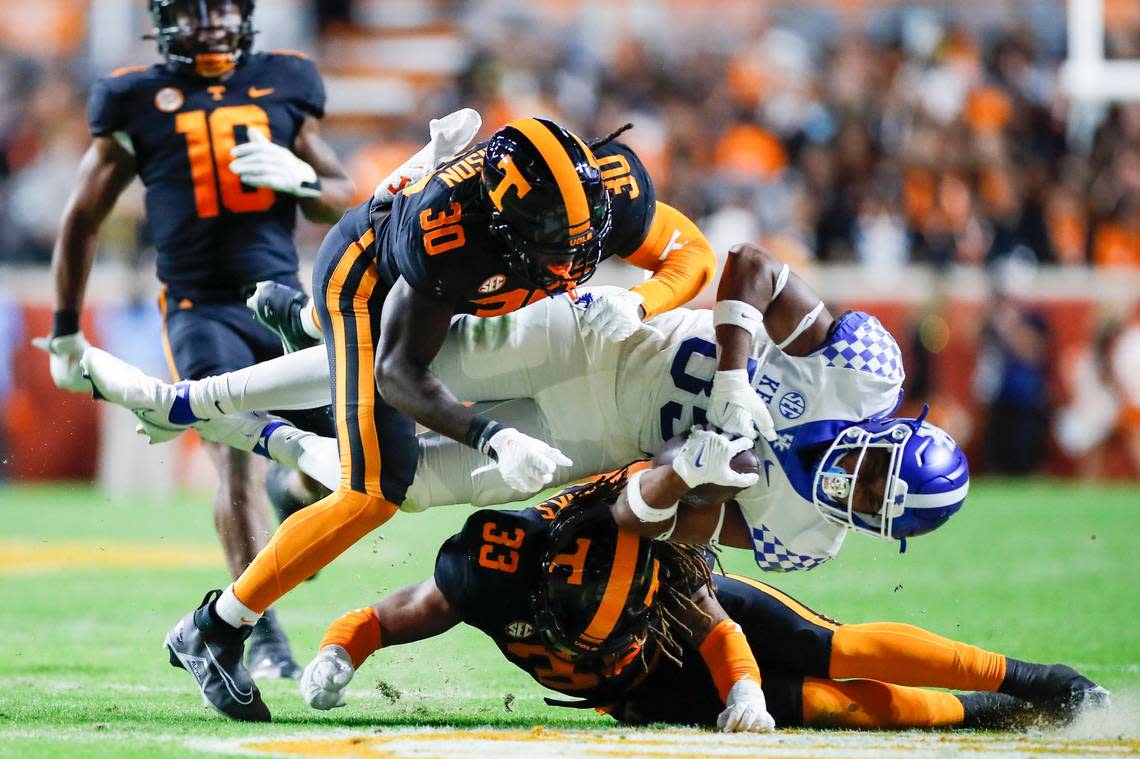 Kentucky Wildcats tight end Jordan Dingle (85) is hit any Tennessee Volunteers defensive lineman Roman Harrison (30) and Tennessee Volunteers linebacker Jeremy Banks (33) during the game at Neyland Stadium in Knoxville, Tn., Saturday, October 29, 2022.