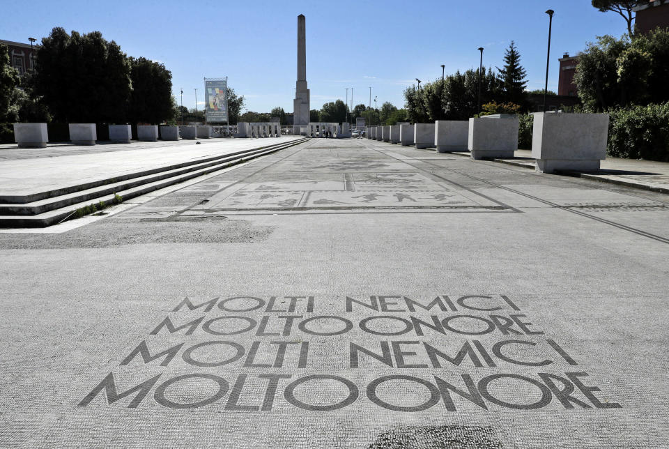 FILE - A Fascist motto reading in Italian "Many enemies, much honor", decorates the mosaic pavement on the avenue from the Olympic stadium to a fascist-era obelisk, in Rome's Foro Italico sporting ground, Thursday, May, 16, 2019. The Brothers of Italy party has won the most votes in Italy’s national election. The party has its roots in the post-World War II neo-fascist Italian Social Movement. Giorgia Meloni has taken Brothers of Italy from a fringe far-right group to Italy’s biggest party. (AP Photo/Gregorio Borgia, File)