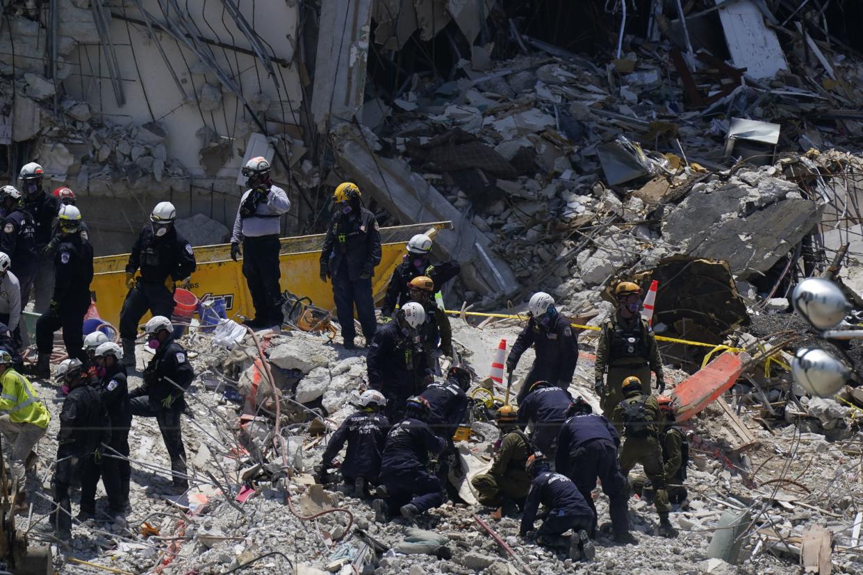 Search and rescue personnel work atop the rubble at the Champlain Towers South condo building, where scores of victims remain missing more than a week after it partially collapsed, Friday, July 2, 2021, in Surfside, Fla.