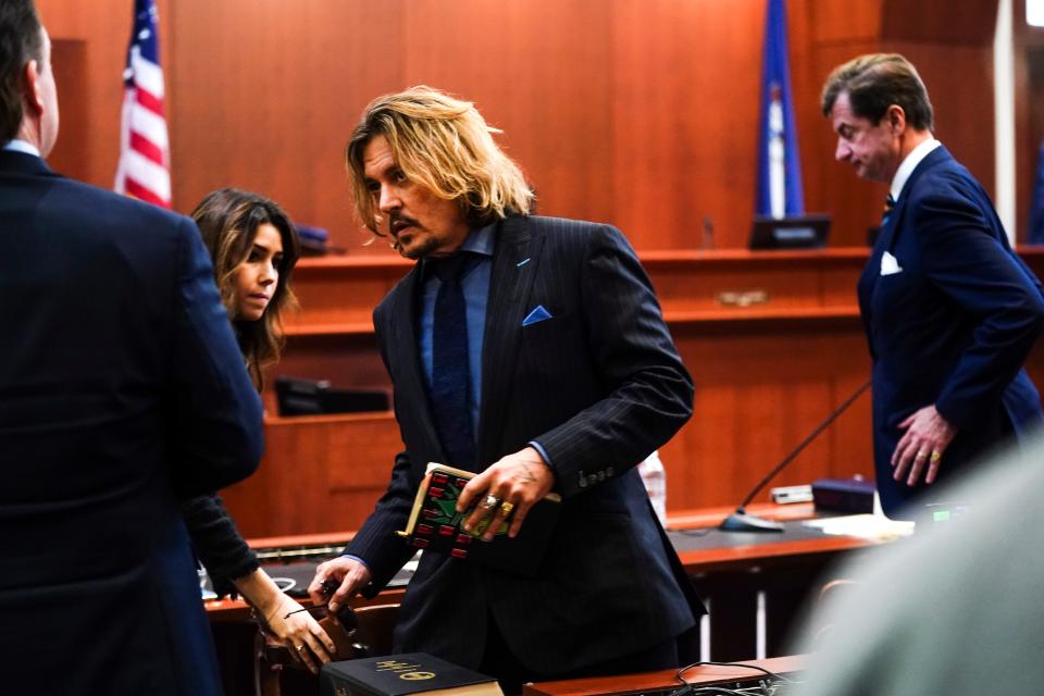 Depp in court with his legal team this morning (EPA)