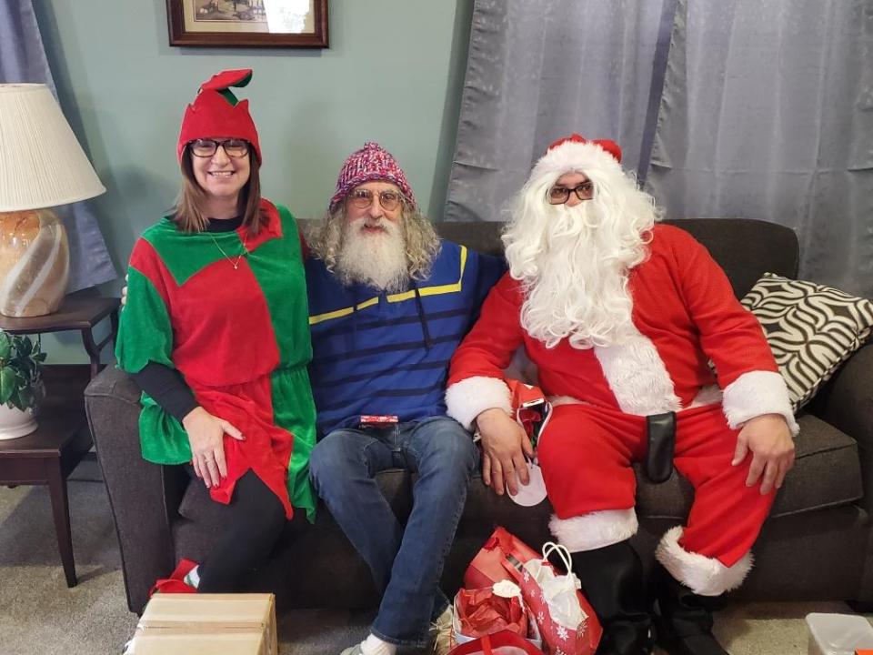 Santa and an elf share some Christmas spirit with a resident at Hilltop Villa in Wooster on Monday.