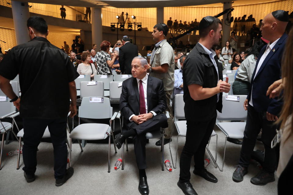 Former Israeli prime minister and leader of the opposition, Benjamin Netanyahu, center, attends a memorial ceremony for Israeli soldiers who fell in battle during the 2014 Gaza War, in the Hall of Remembrance at Mount Herzl Military Cemetery, in Jerusalem, Israel, Sunday, June 20, 2021. (Abir Sultan/Pool Photo via AP)