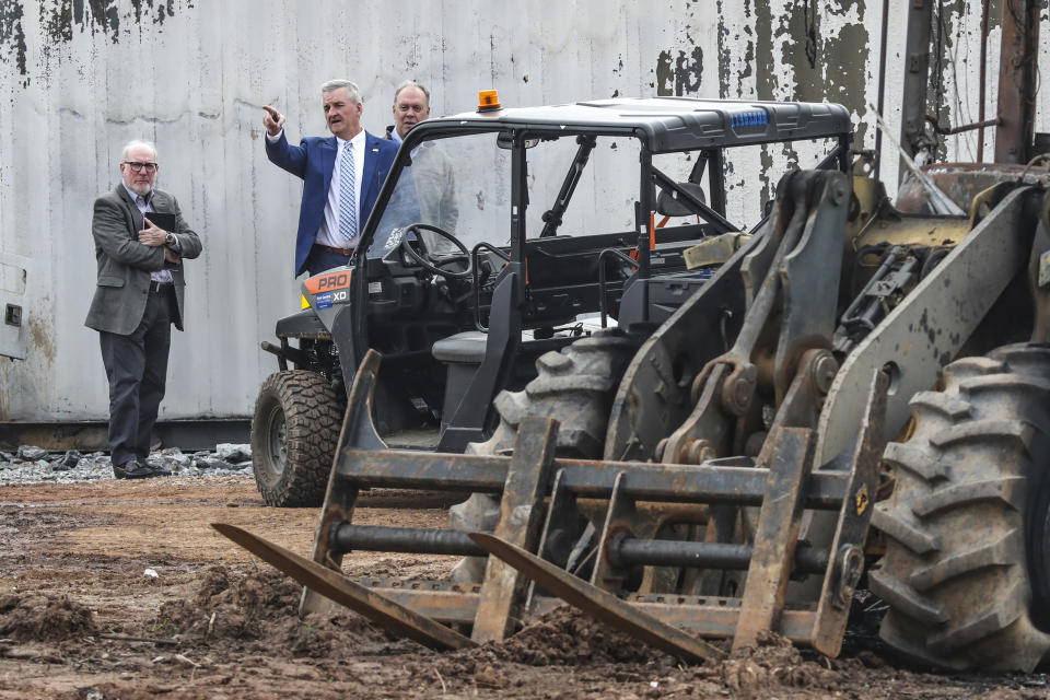 Dave Wilkinson, President and CEO of the Atlanta Police Foundation, center, examines damaged property at the Atlanta Public Safety Training Center in DeKalb County, Ga., Monday, March 6, 2023. More than 20 people from around the country faced domestic terrorism charges Monday after dozens of young men in black masks attacked the site of a police training center under construction in a wooded area outside Atlanta where one protester was killed in January. (John Spink/Atlanta Journal-Constitution via AP)