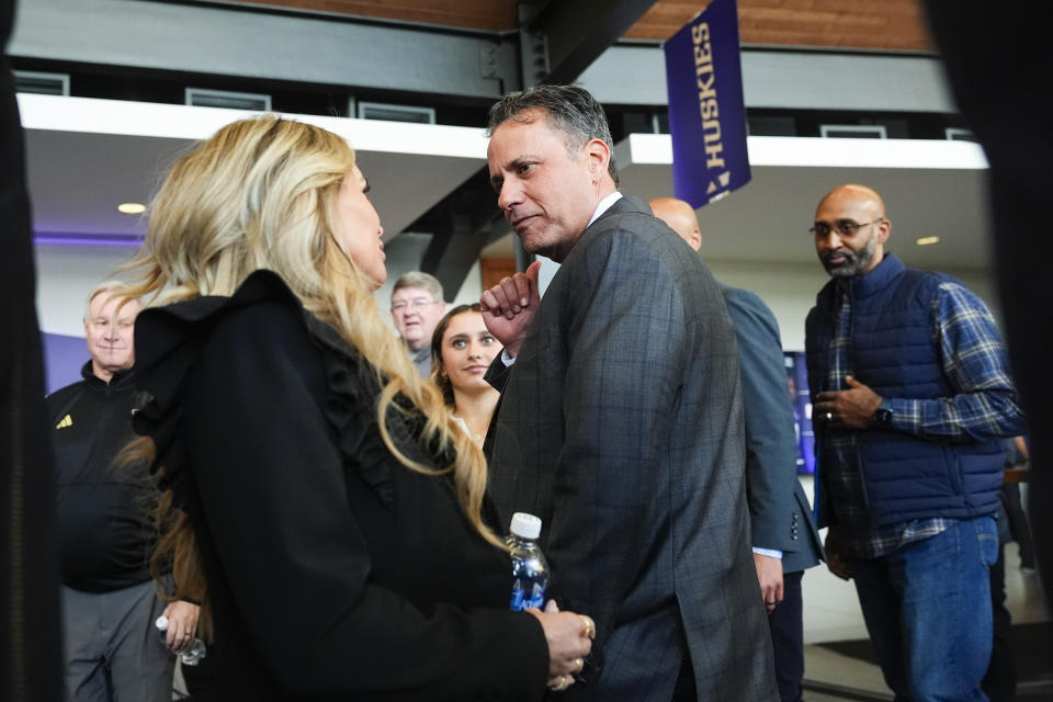 New Washington head coach Jedd Fisch talks with wife Amber after an NCAA college football press conference Tuesday, Jan. 16, 2024, in Seattle. (AP Photo/Lindsey Wasson)