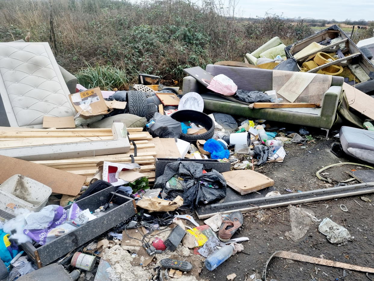 Piles of furniture, fridges, tyres and household and industrial waste litter the road. (SWNS)