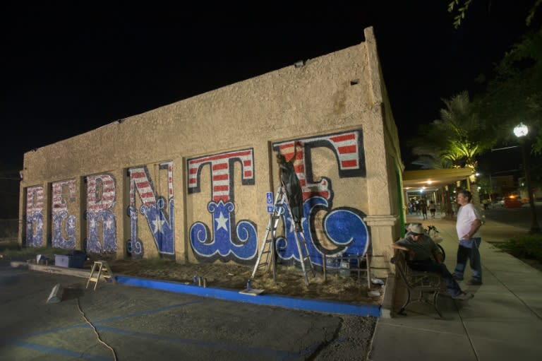 Jules Muck paints a mural honoring Democratic presidential hopeful Bernie Sanders during a two-day free concert event dubbed "Berniechella", on April 21, 2016 in Coachella, California