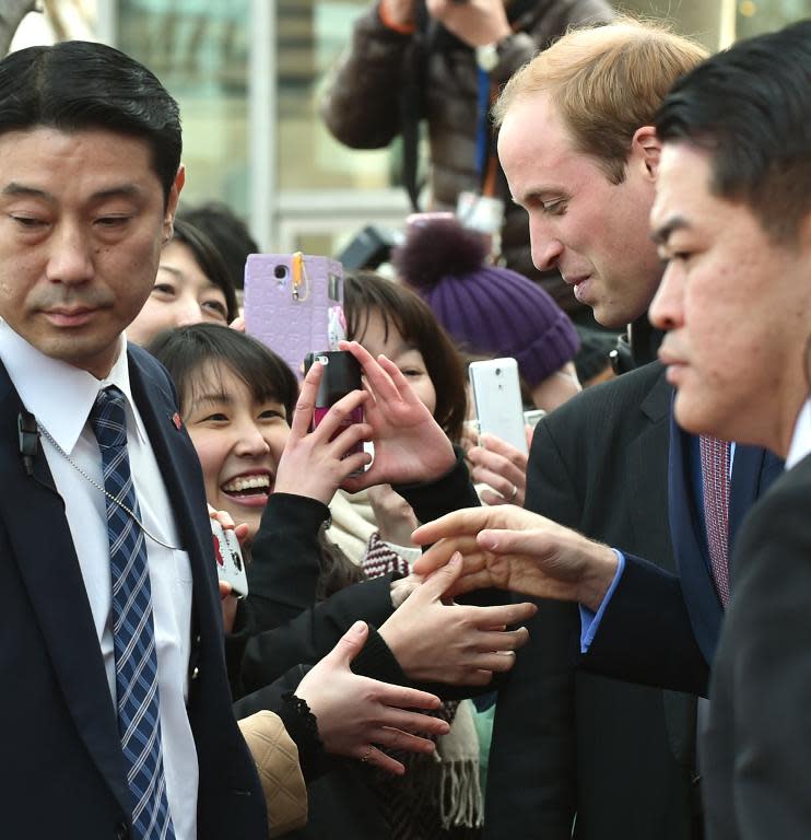 Britain's Prince William meets with Japanese well-wishers after launching a public exhibition at a Tokyo bookshop on February 28, 2015