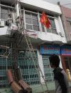 Workers remove a fallen television tower in the aftermath of Typhoon Haiyan in Vietnam's northern Quang Ninh province, 112 miles away from Hanoi, November 11, 2013. (REUTERS/Kham)