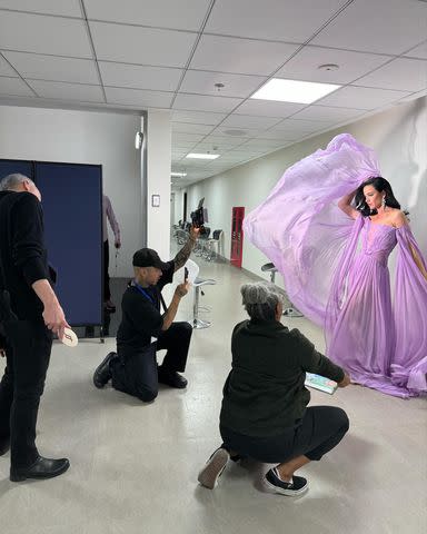 <p>Katy Perry/ Instagram</p> Katy Perry poses in a purple Cong Tri chiffon gown at the VinFuture Prize awards ceremony in Vietnam