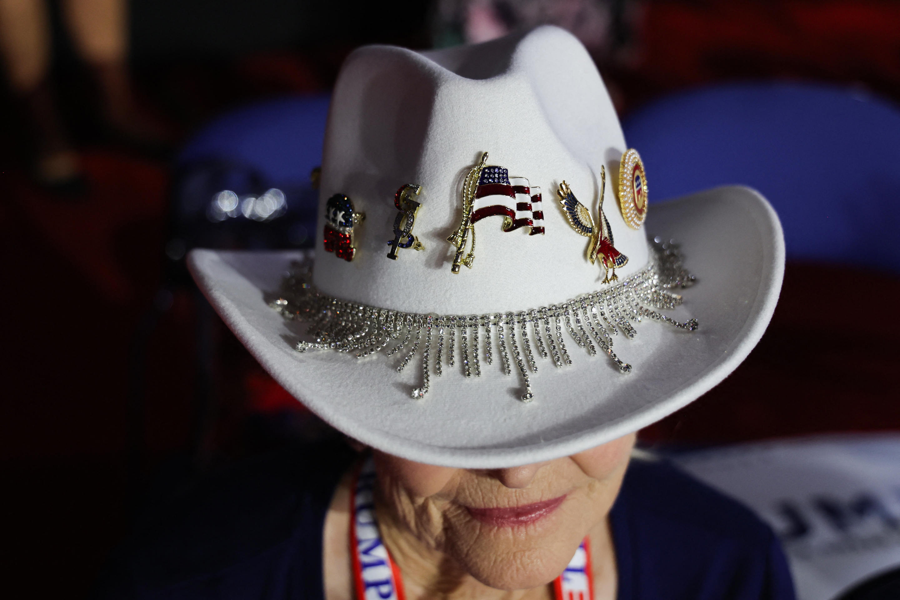 A woman wears a decorated cowboy hat at the convention on day one. 