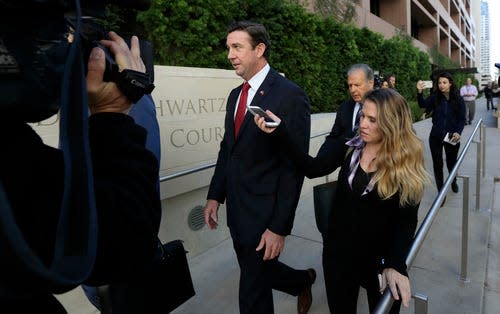 FILE - In this Dec. 3, 2018 file photo Republican Rep. Duncan Hunter, center, leaves court in San Diego. (AP Photo/Gregory Bull, File) ORG XMIT: LA701