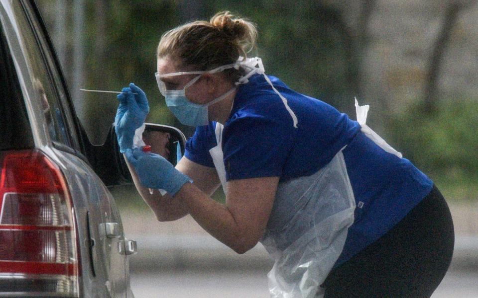 A nurse is seen swabbing the occupants of a car at a drive through COVID-19 testing station at Chessington World Of Adventures Resort  - Getty