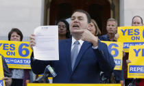 Carl DeMaio, who is leading the Proposition 6 campaign to repeal a recent gas tax increase, gestures to a ballot measure he is proposing to provide money for road repairs and eliminate high-speed rail on Tuesday, Sept. 25, 2018, in Sacramento, Calif. The 2020 initiative would change the state constitution to require that revenue from existing gas taxes be spent only for road and bridge work. (AP Photo/Rich Pedroncelli)