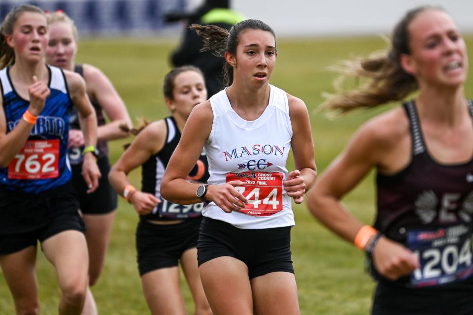 Mason's Meghan Ford, center, approaches the finish line during the Division 2 girls state cross country final on Saturday, Nov. 5, 2022, at Michigan International Speedway in Brooklyn.