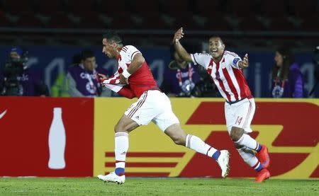 Paraguay's Lucas Barrios celebrates after scoring the equalizing goal against Argentina as his teammate Paulo Da Silva (R) cheers him on during their first round Copa America 2015 soccer match against Argentina at Estadio La Portada de la Serena in La Serena, Chile, June 13, 2015. REUTERS/Mariana Bazo